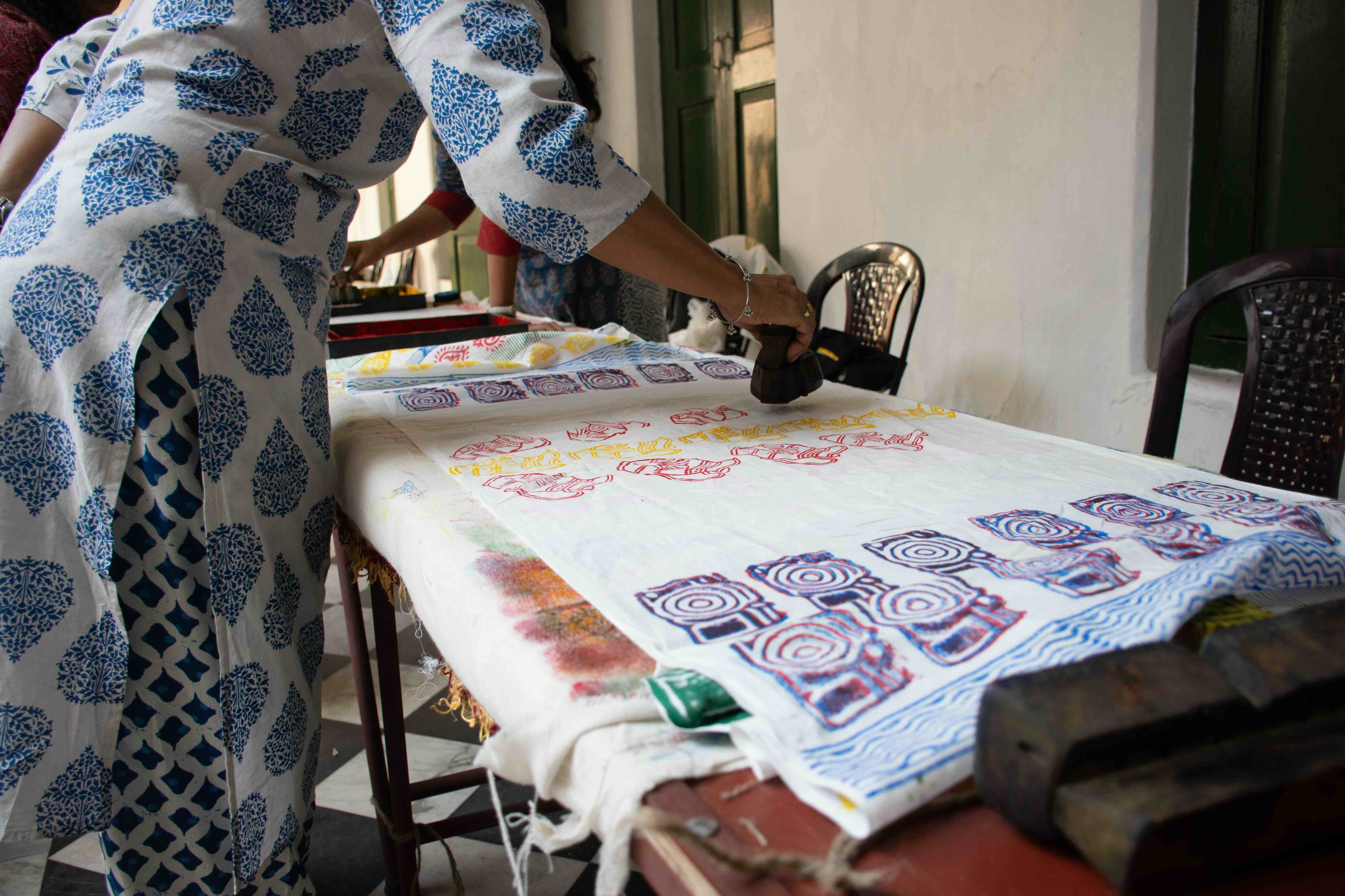 Hands block printing fabric